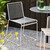 Two HAY Hee Outdoor Dining Chairs next to a table on a patio