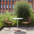 Two HAY Hee Outdoor Dining Chairs next to a table on a patio