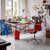 Vitra Eames EA 131 / EA 132 Chair in Fabric by an art desk Vitra Eames EA 131 / EA 132 Chair in Fabric by an art desk