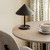 Mater Terra Portable Lamp in Coffee Waste Black on a table Mater Terra Portable Lamp in Coffee Waste Black on a table