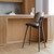 Mater High Backrest Stool next to a bar
