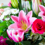 Example photo of valentine's designer's choice flowers. Pink stargazer lilies, pink tulips, hot pink roses, white button chrysanthemums, and hot pink stock will make the perfect color combination for a valentine's designer's choice arrangement.  