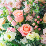 Example photo of valentine's designer's choice flowers. Yellow lisianthus, peach roses, pink hypericum berries, pink majolica spray roses, and peach stock will make the perfect color combination for a valentine's designer's choice arrangement. 