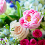 Example photo of valentine's designer's choice flowers. Pink debutant tulips, blush pink roses, hot pink spray roses, white waxflower, and blue delphinium create a perfect color combination for a valentine's designer's choice arrangement. 