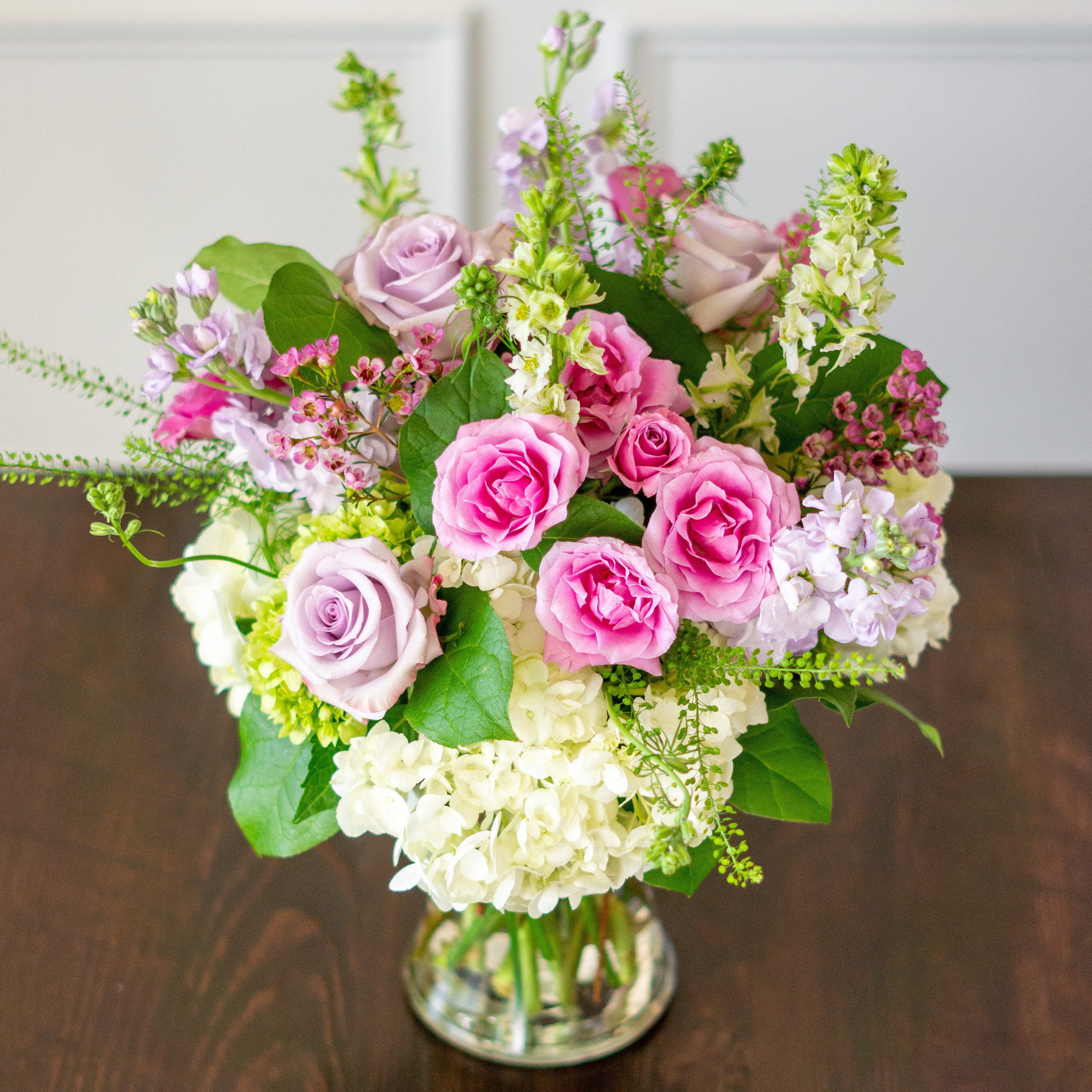 Peach valentines day flower arrangement for delivery to Charlotte NC. Image is a closeup of a pink rose with a peach center surrounded by peach stock and pink majolika spray roses. 