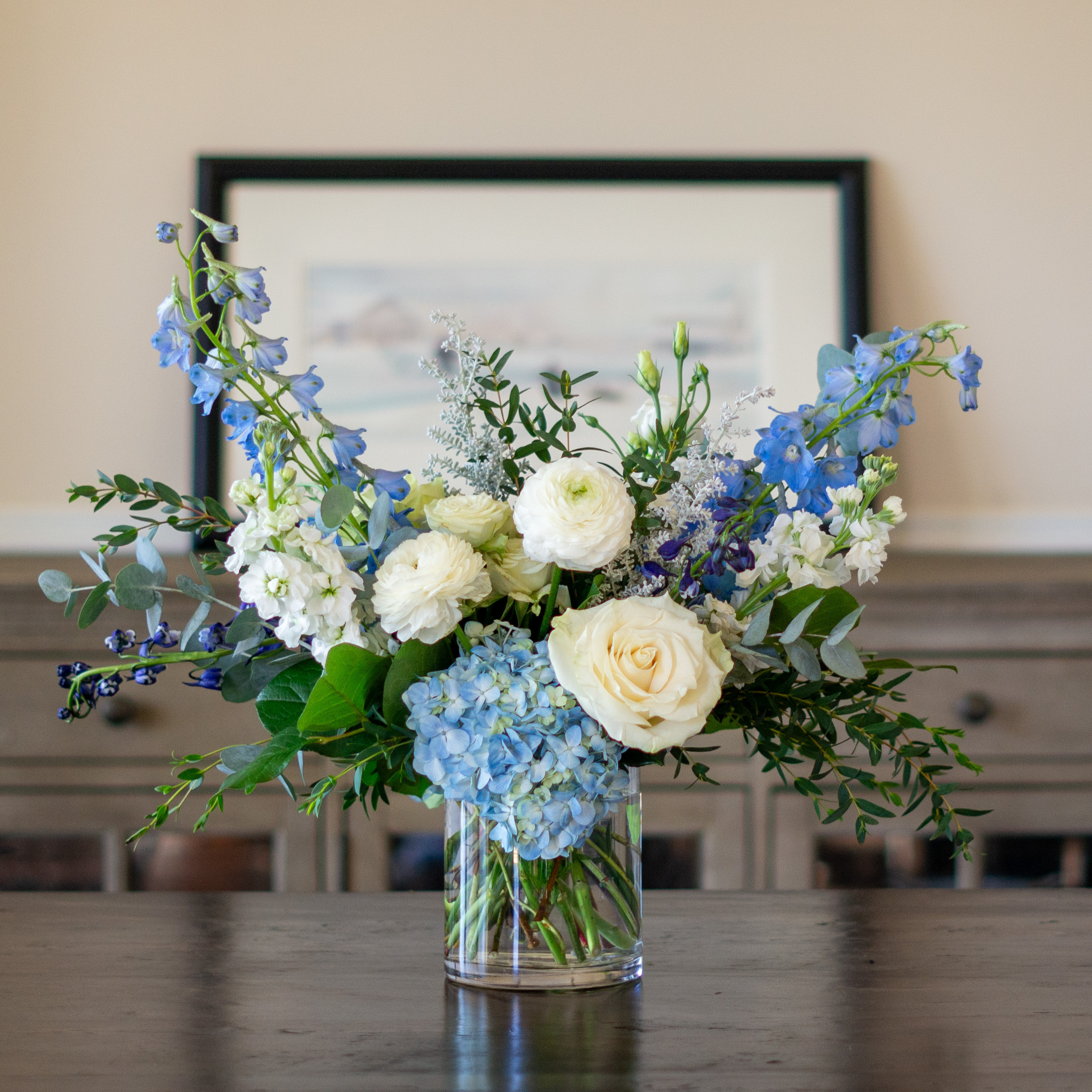 Large Valentines Day flowers for delivery to Charlotte, NC. Image shows a large garden style arrangement of peach roses, peach stock, white hydrangea, cream lisianthus, pink hypericum berries, and pink spray roses accented with spiral eucalyptus and gunni. 