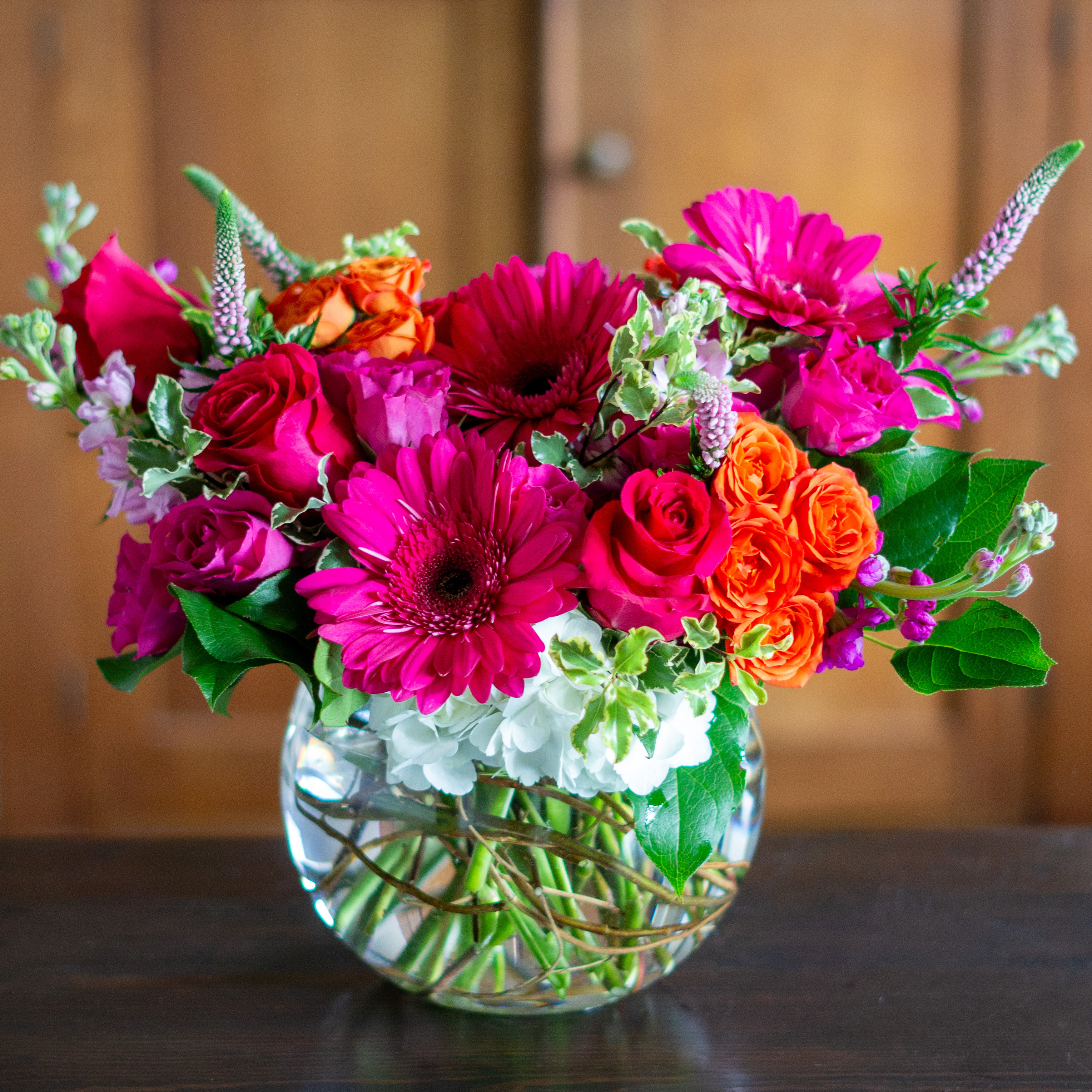 Peach valentines day flower arrangement for delivery to Charlotte NC. Image is a closeup of a pink rose with a peach center surrounded by peach stock and pink majolika spray roses. 