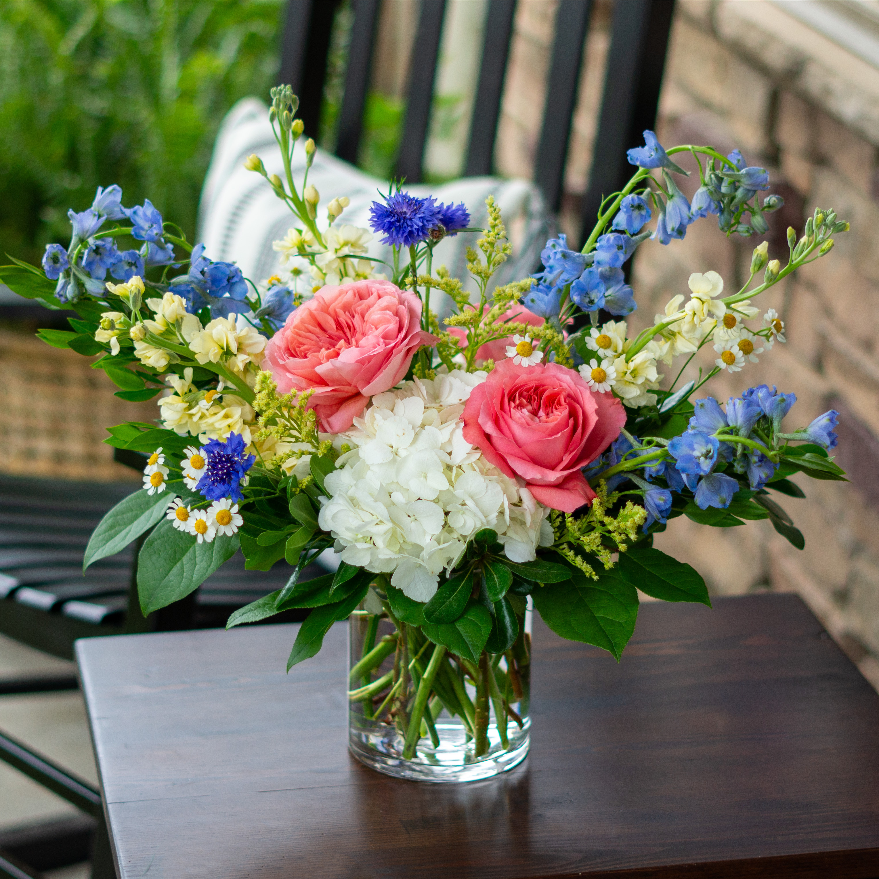 Large Valentines Day flowers for delivery to Charlotte, NC. Image shows a large garden style arrangement of peach roses, peach stock, white hydrangea, cream lisianthus, pink hypericum berries, and pink spray roses accented with spiral eucalyptus and gunni. 