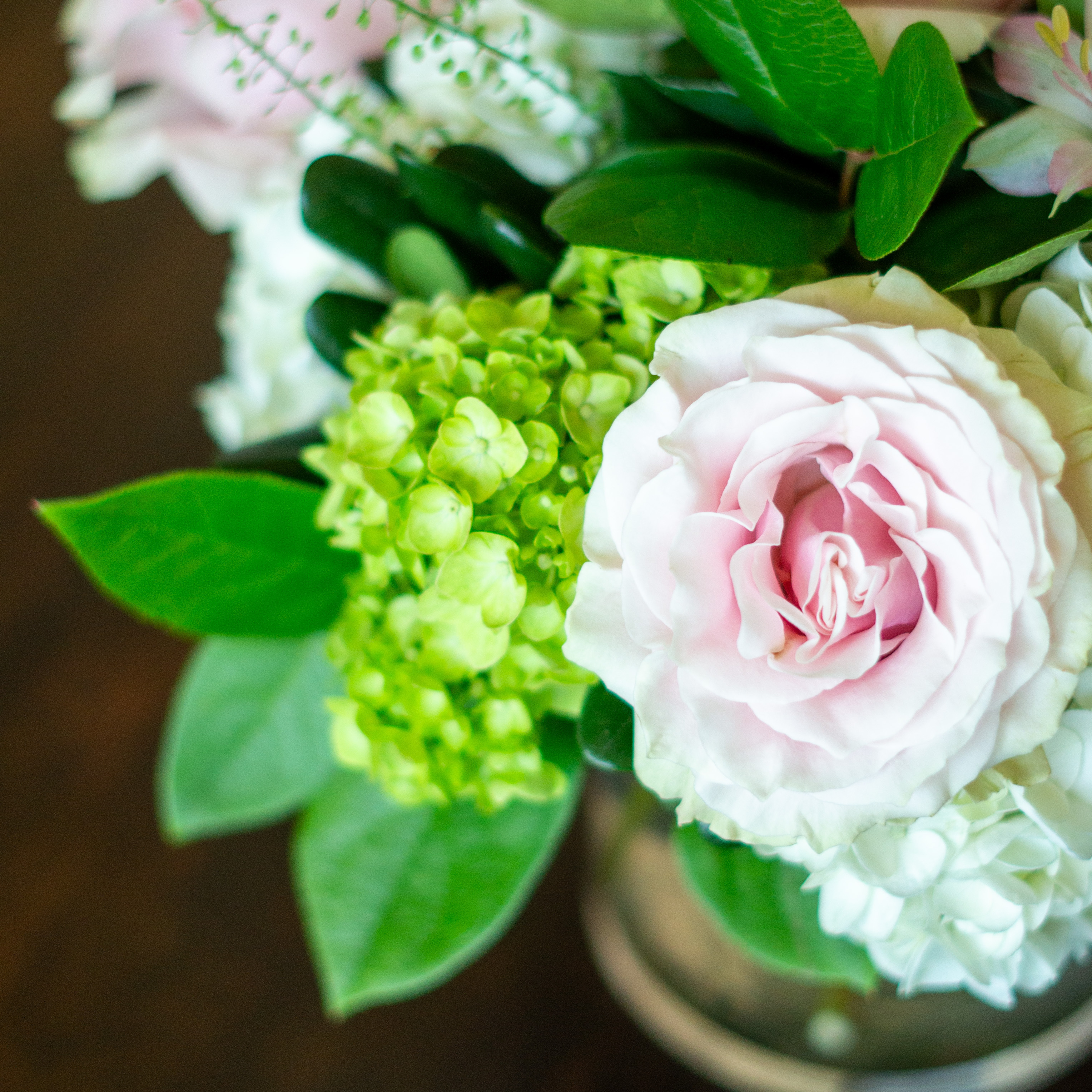 Large Valentines Day flowers for delivery to Charlotte, NC. Image shows a large garden style arrangement of peach roses, peach stock, white hydrangea, cream lisianthus, pink hypericum berries, and pink spray roses accented with spiral eucalyptus and gunni. 