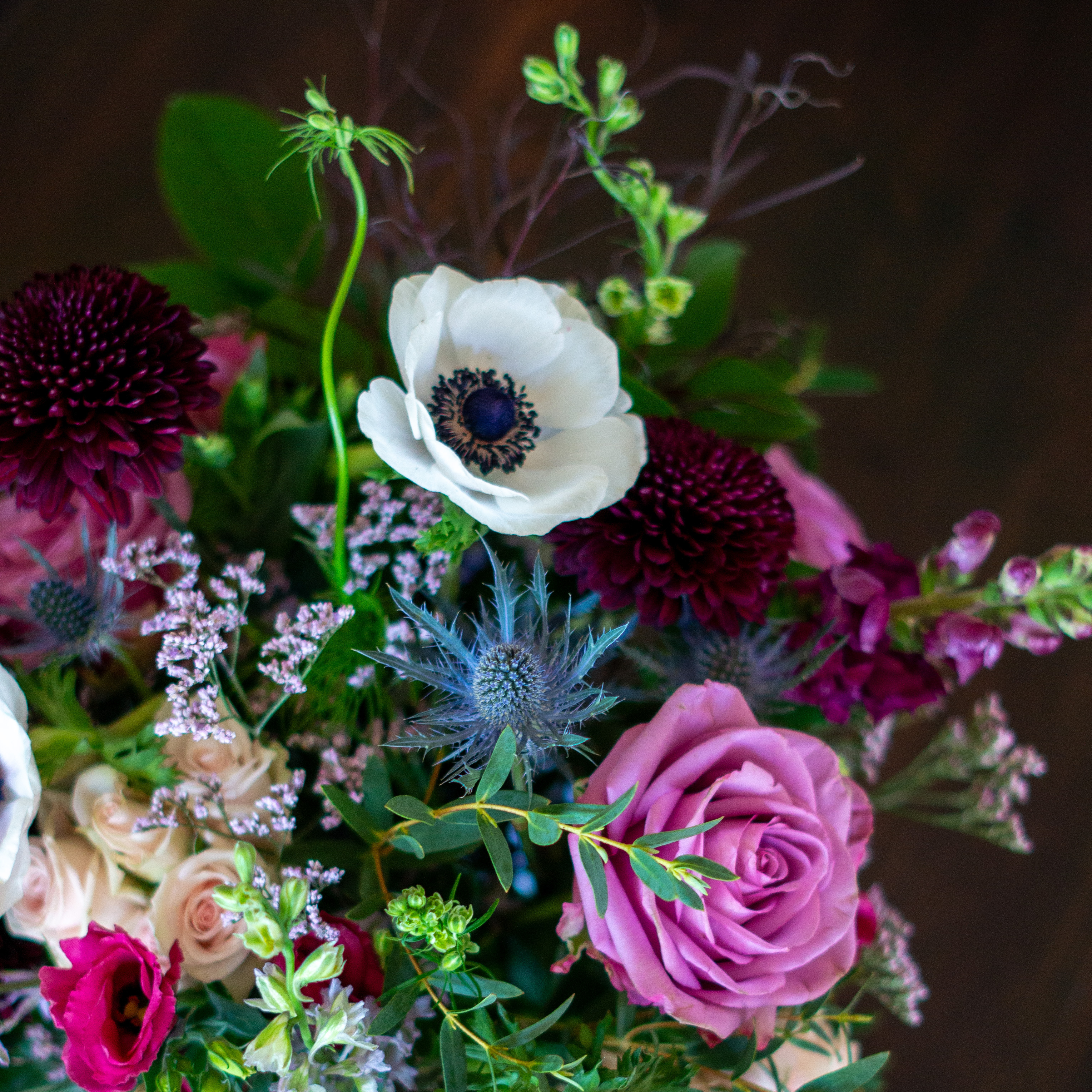 Large Valentines Day flowers for delivery to Charlotte, NC. Image shows a large garden style arrangement of peach roses, peach stock, white hydrangea, cream lisianthus, pink hypericum berries, and pink spray roses accented with spiral eucalyptus and gunni. 