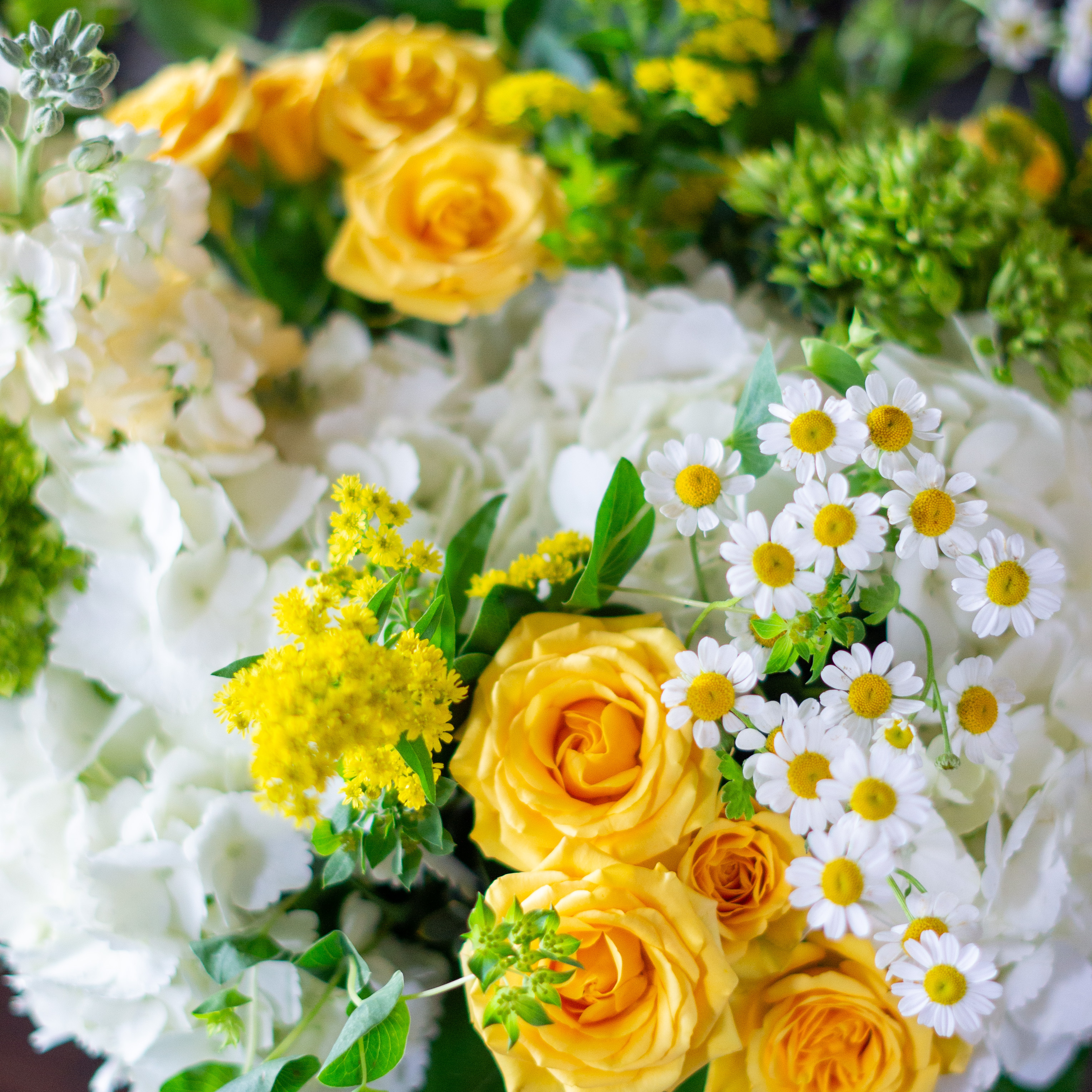 Large Valentines Day flowers for delivery to Charlotte, NC. Image shows a large garden style arrangement of peach roses, peach stock, white hydrangea, cream lisianthus, pink hypericum berries, and pink spray roses accented with spiral eucalyptus and gunni. 