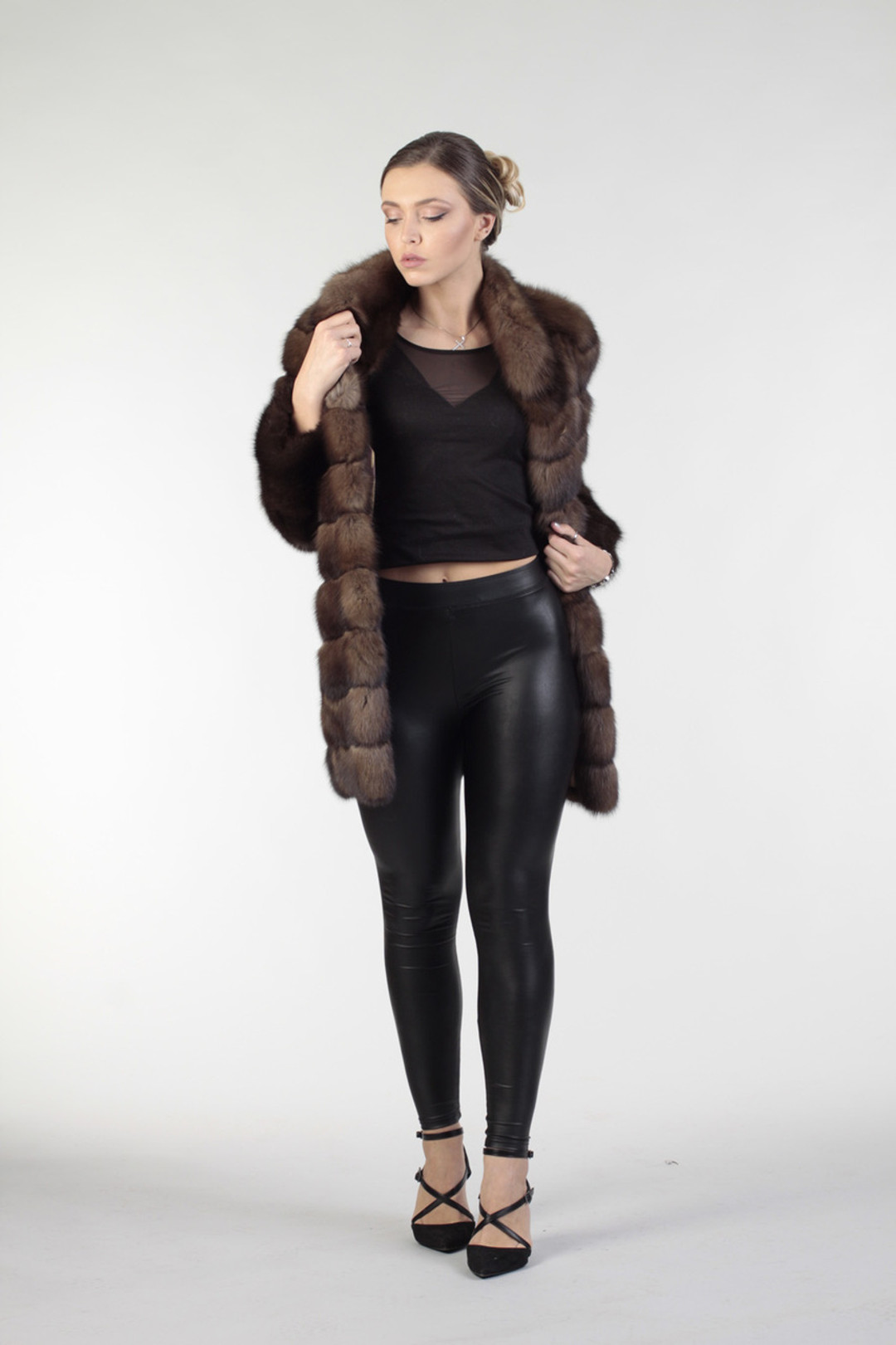 brown sable fur coat mid hip length unfastened on blonde russian model wear black sleeveless top and tight leather pants brown sable fur coat mid hip length unfastened on blonde russian model wear black sleeveless top and tight leather pants