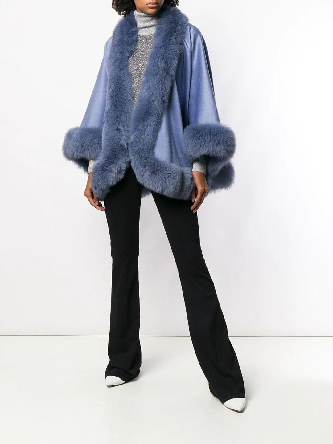 blue cashmere cape with fox trim on model wearing black pants blue cashmere cape with fox trim on model wearing black pants