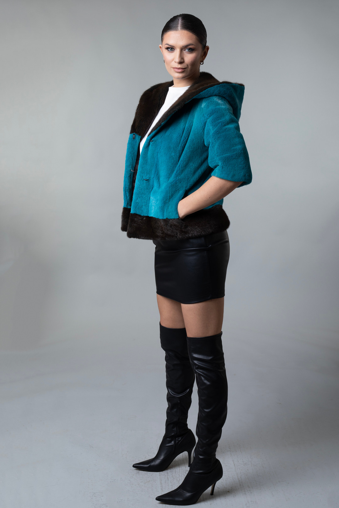 Short Hooded Turqoise Black  Mink Jacket Cropped Sleeves on model profile view Short Hooded Turqoise Black  Mink Jacket Cropped Sleeves on model profile view