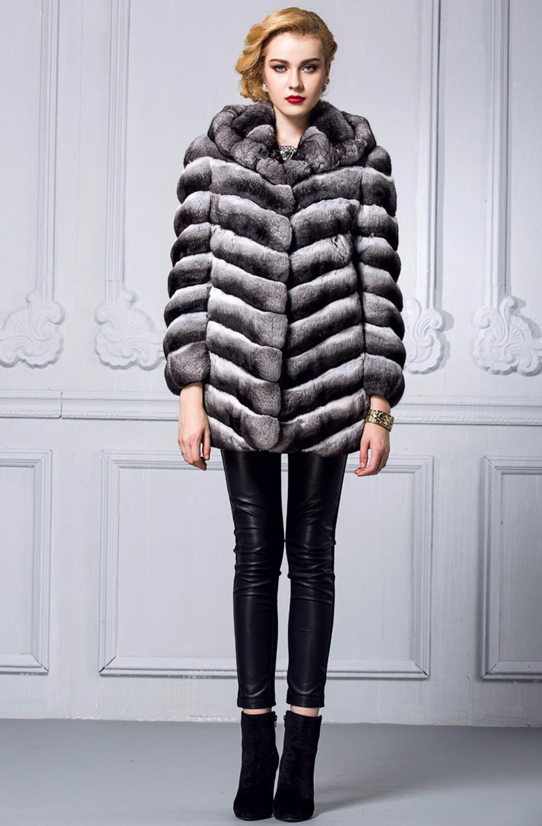 chinchilla coat with hood on model , full body view , matched with black leather tight pants and ankle height castor boots , accessorized with golden bracelet chinchilla coat with hood on model , full body view , matched with black leather tight pants and ankle height castor boots , accessorized with golden bracelet
