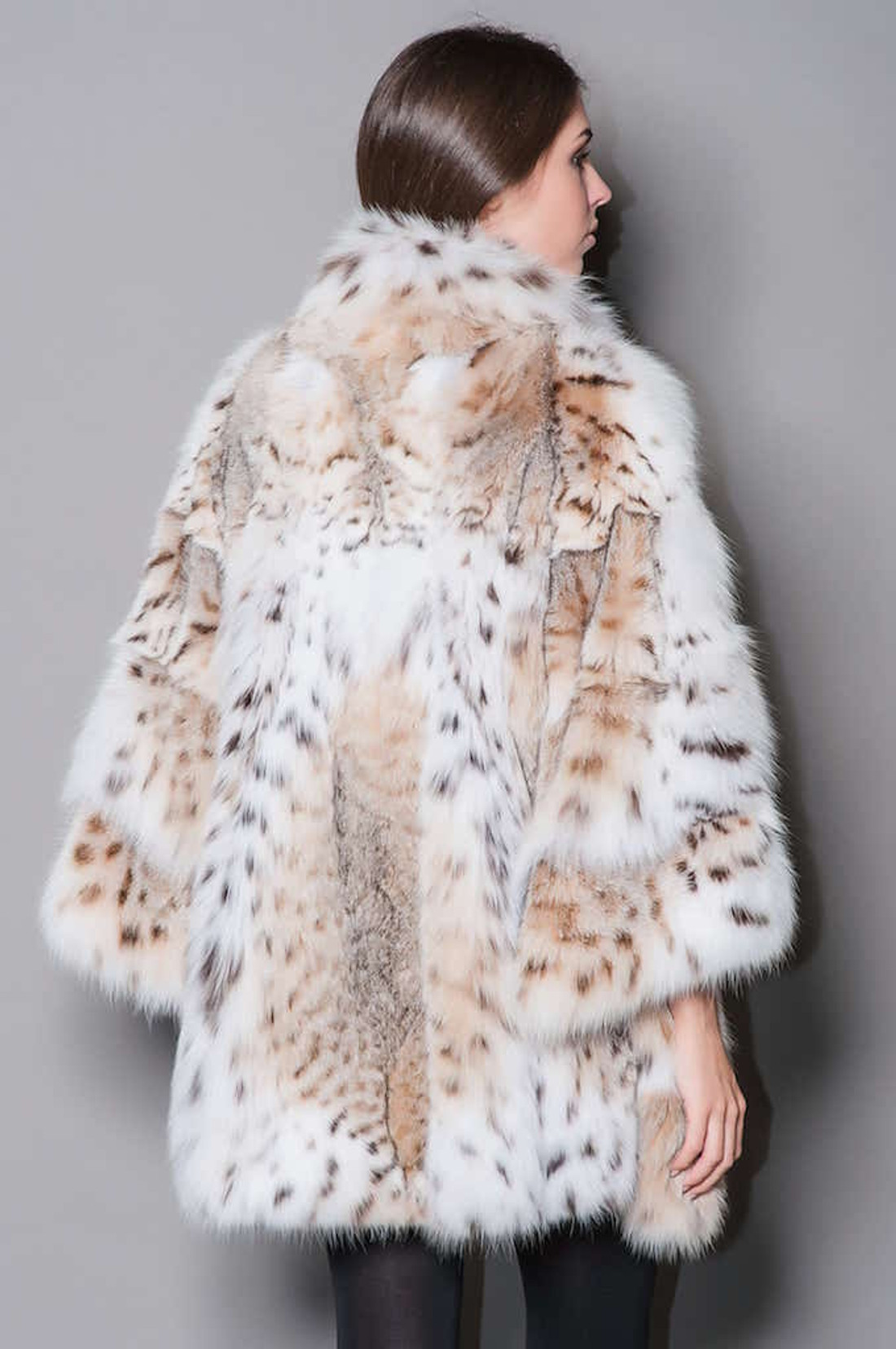 lynx coat with pure white lynx fur collar , widened sleeves and bottom sweep with flare on model rear view