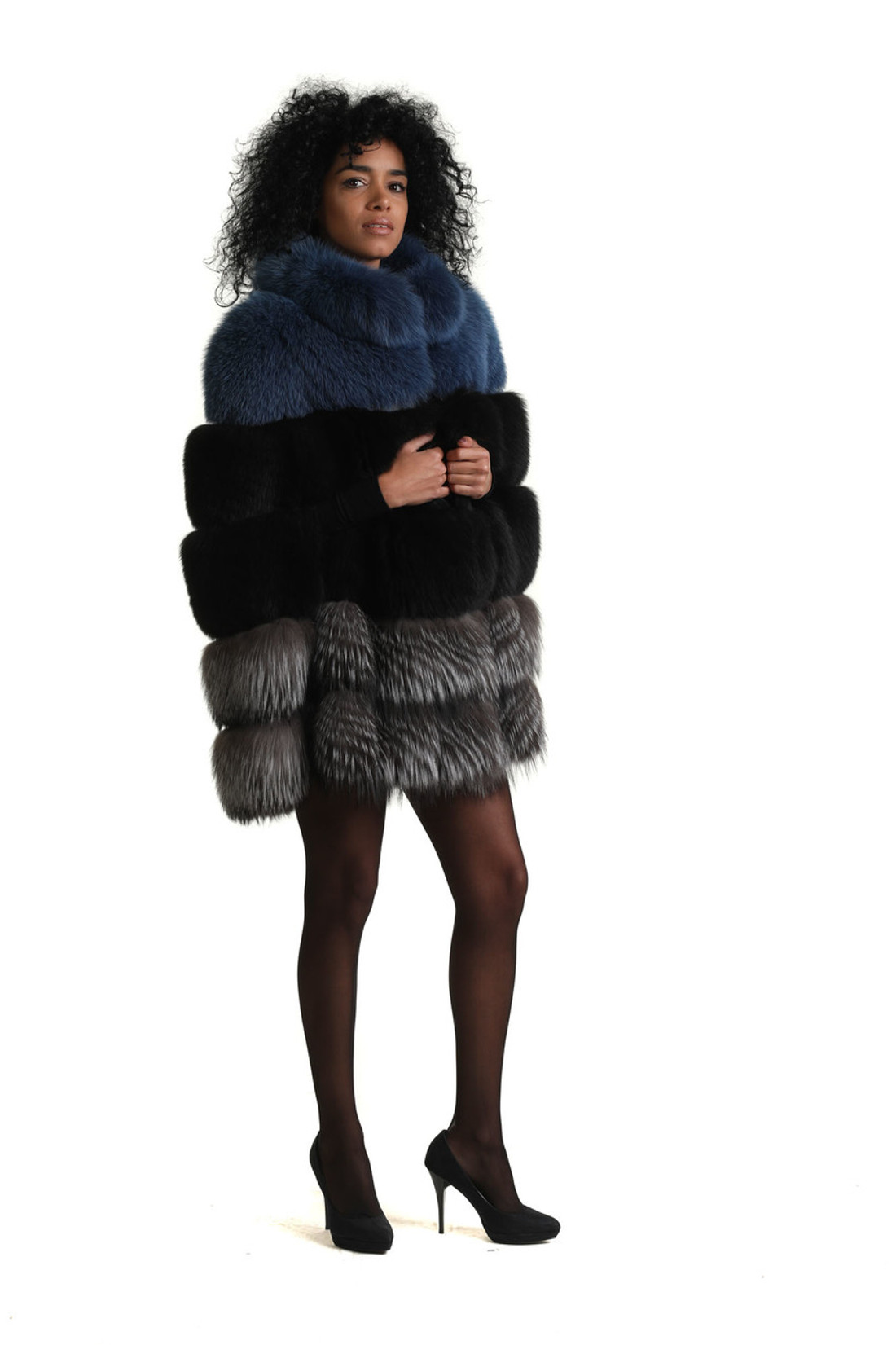 profile view of blue black and silver fox fur cape on model with mini dress and black leather high heels
