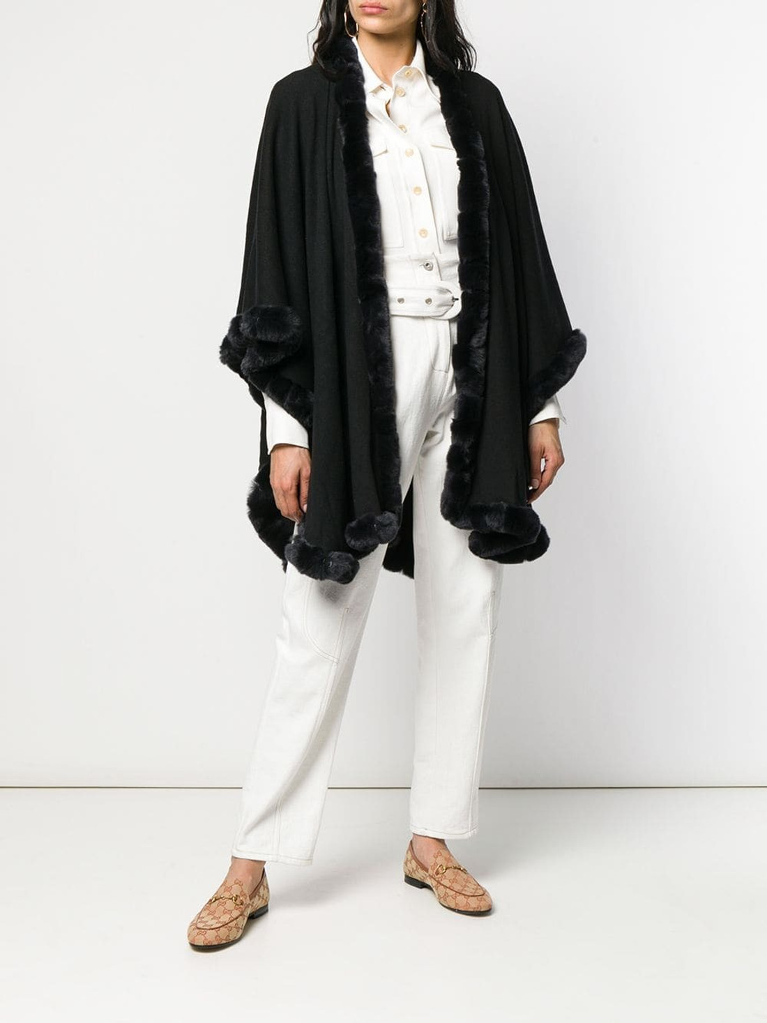 black cashmere cape with rex fur trim on model wearing white shirt and linen pants and beige flat shoes black cashmere cape with rex fur trim on model wearing white shirt and linen pants and beige flat shoes