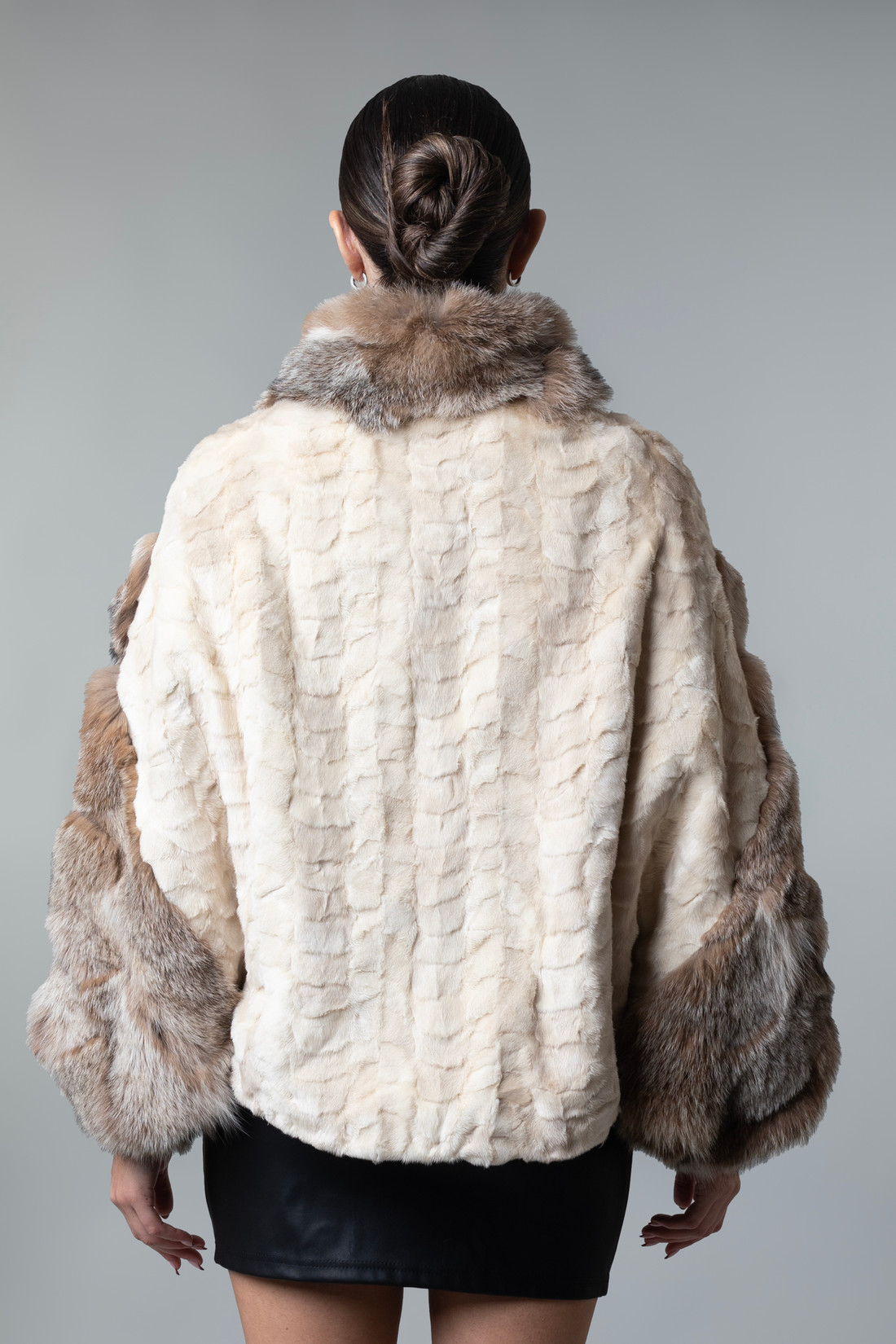 Mink fur cpae with lynx sleeves and collar on model rear view