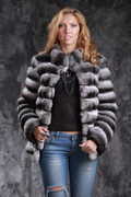 chinchilla coat with v-neck collar on model wearing  fishnet blouse and  ripped jeans, accessorized with silver keychains and matching rings chinchilla coat with v-neck collar on model wearing  fishnet blouse and  ripped jeans, accessorized with silver keychains and matching rings
