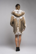 back view of hooded lynx fur coat on model with fox on the luscious hood