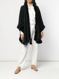 black cashmere cape with rex fur trim on model wearing white shirt and linen pants and beige flat shoes black cashmere cape with rex fur trim on model wearing white shirt and linen pants and beige flat shoes