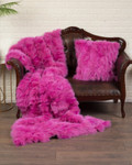 pink fox fur blanket on couch with matching fox fur pillow