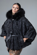 black astrakhan cape hooded with fox trim leather belt on model close up black astrakhan cape hooded with fox trim leather belt on model close up