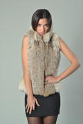 lynx fur vest  , waist lengthwith short stand up round collar on model matched with black mini cocktail dress