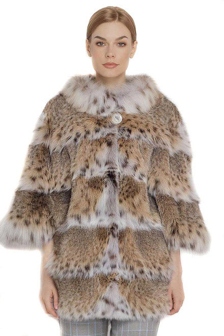 lynx fur coat stitched with skins acrooss elbow length sleeves and white lynx collar on blond model with checked cotton pants and elegant haircut