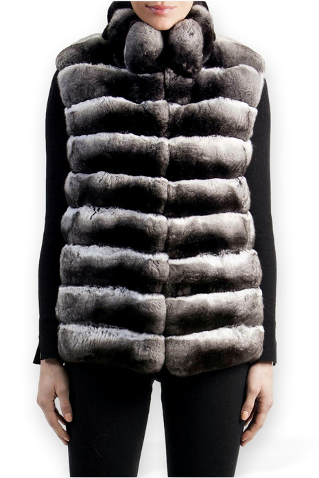 chinchilla vest with stand up collar worn over black tight blouse with sleeve slits and black tight pants chinchilla vest with stand up collar worn over black tight blouse with sleeve slits and black tight pants