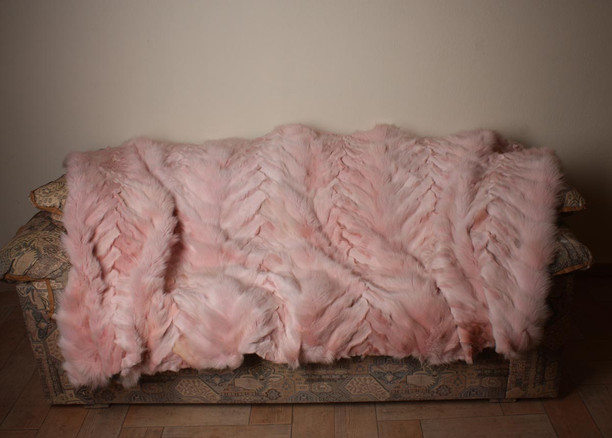 light pink fox fur blanket on sofa chevron pattern