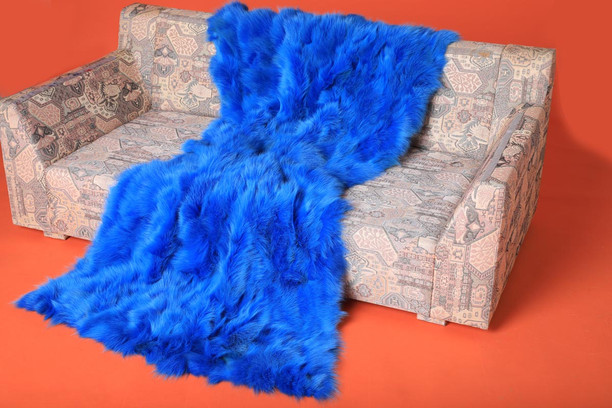 neon blue fox fur blanket throw  on sofa