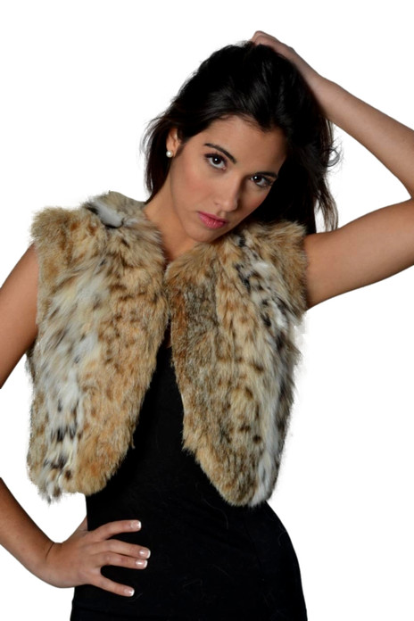 Lynx Fur Bolero cropped above waist , collarless and reverse v opening on bottom , worn by gorgeous brunette model with tight black dress , Lynx Fur Bolero cropped above waist , collarless and reverse v opening on bottom , worn by gorgeous brunette model with tight black dress ,