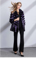 Purple chinchilla coat with wide bottom sweep , 4/5 length cropped sleeves on model wearing black blouse,black bell bottom pants and black leather heels