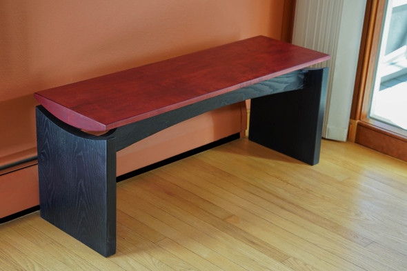 Red and black bench with floating top by Alan Kalker