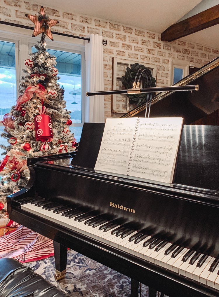 Piano light installed on grand piano with christmas decorations