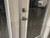 Glass door with a deadbolt and handle shown without any cat eye security stickers applied.