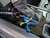 Blue and yellow paracord knot-head keychain figure attached to car keys resting on a center console.