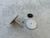 Disassembled bolt spool components including a bolt, two metal plates, washer, and a  spacer arranged on a concrete surface.