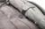 Close up of Pack Point attached to a backpack holding an umbrella with velcro straps.
