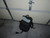 A backpack laid on the ground with a bundle of black reflective tracer paracord, showing the reflective nature of the cord.