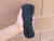 Hand holding a bundle of black reflective tracer paracord.

