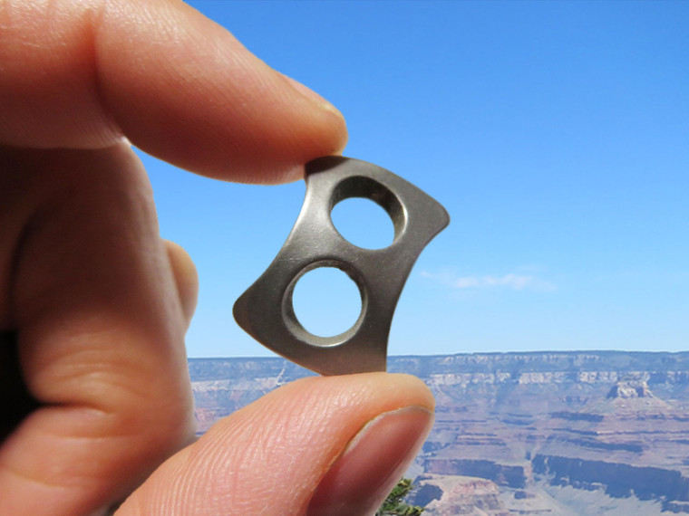 Person holding Paralink showing small size and lightweight everyday carry design.