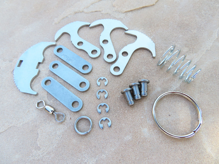 Gravity XS kit components laid out on a surface, including stainless steel parts and keyring accessories.