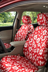 Hawaiian seat covers on front buckets, bright red with white hibiscus print covering headrests, backrests, and cushions.