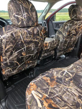 Rear view of front truck seats with Realtree Waterproof Camo covers, showing the precise fit and integrated storage pockets on the seat backs.