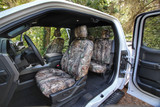 Realtree Waterproof Camo Seat Covers installed in a truck interior, camo pattern on front and rear seats for durable protection.
