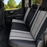 Saddle Blanket seat covers on truck rear bench, grey salt-and-pepper weave with black stripes, black bolsters, and armrest.