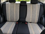 Saddle Blanket seat covers on rear bench, heathered grey weave with tan stripes and solid black sides and headrests.